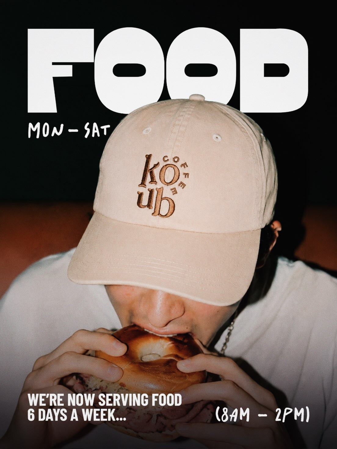 A Coffee Koub customer eating a generously filled bagel